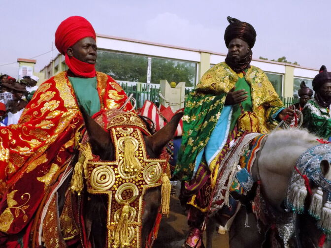 Members of Kano's Royal Family arrive on horseback at the Eid prayer grounds in Kano on June 25, 2017, ahead of prayers to mark the end of the holy month of Ramadan and the start of the Eid al-Fitr Festival. 			 / AFP PHOTO / AMINU ABUBAKAR        (Photo credit should read AMINU ABUBAKAR/AFP/Getty Images)