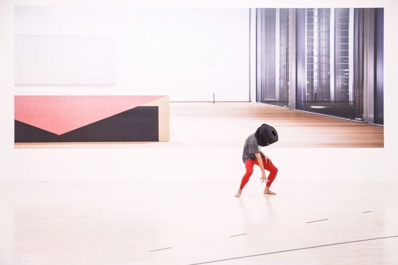 A dancer performs solo in an art gallery.