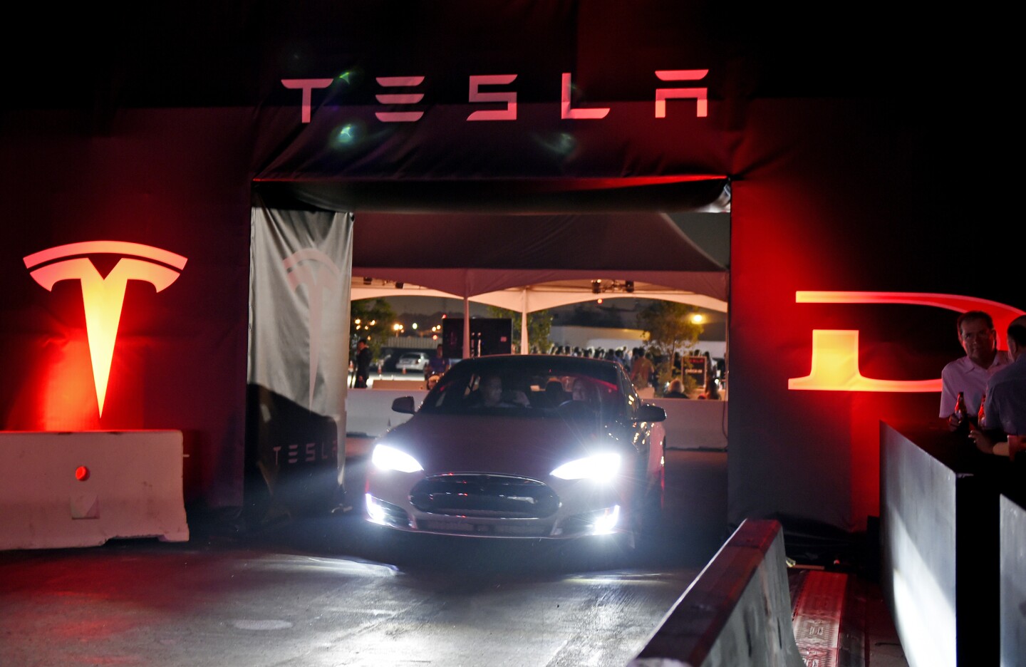 HAWTHORNE  CA - OCTOBER 09: Tesla owners take a ride in the new Tesla "D" model electric sedan after Elon Musk, CEO of Tesla, unveiled the dual engine chassis of the new Tesla 'D' model, a faster and all-wheel-drive version of the Model S electric sedan, at the Hawthorne Airport October 09, 2014 in Hawthorne, California. The D will be able to accelerate to 60 miles per hour in just over 3 seconds. (Photo by Kevork Djansezian/Getty Images)