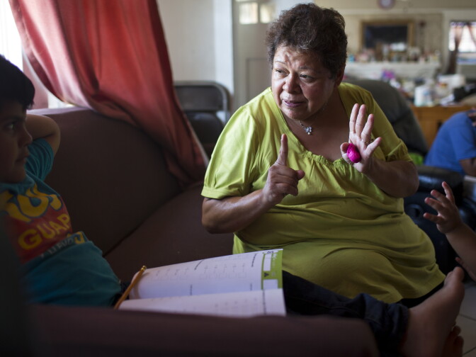 Maria Garcia, 58, works with her grandson, Pablo Andres Garcia, 6, on a math exercise in their South Los Angeles home on Monday afternoon, August 3, 2015.