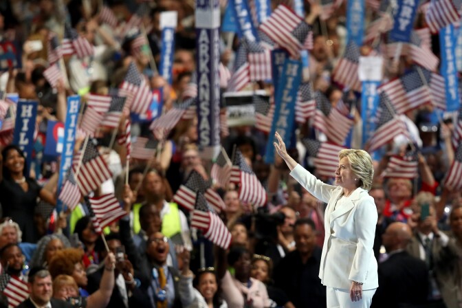 PHILADELPHIA, PA - JULY 28:  Democratic presidential candidate Hillary Clinton acknowledges the crowd as she arrives on stage during the fourth day of the Democratic National Convention at the Wells Fargo Center, July 28, 2016 in Philadelphia, Pennsylvania. Democratic presidential candidate Hillary Clinton received the number of votes needed to secure the party's nomination. An estimated 50,000 people are expected in Philadelphia, including hundreds of protesters and members of the media. The four-day Democratic National Convention kicked off July 25.  (Photo by Joe Raedle/Getty Images)
