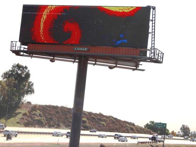 The billboard is located along Interstate 15 in Corona.