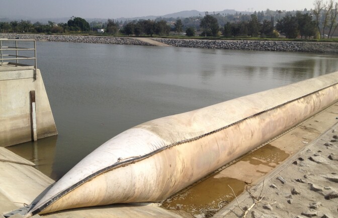 The Orange County Water District uses an inflatable rubber dam across the Santa Ana River in Anaheim to divert river water that would otherwise flow to the ocean. The water flows into one of the district's recharge basins, where it eventually percolates into an underground aquifer that supplies water to 2.4 million Orange County residents. 