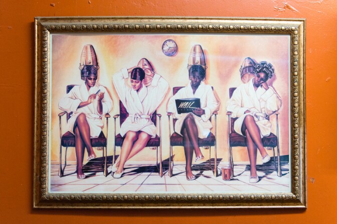 Art hangs in the barbershop.