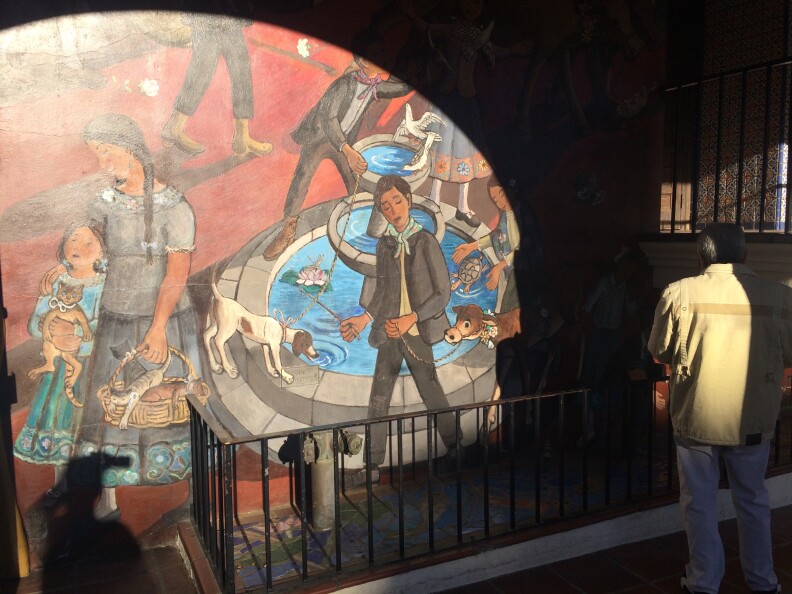 A man stands outside the Mexican Cultural Institute near Olvera Street at the Virgen of Guadalupe celebration in December, 2015.