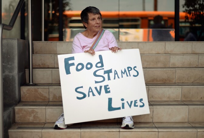 Members of Progressive Democrats of America and other activists hold a rally in front of Rep. Henry Waxman's office on June 17, 2013 in Los Angeles, California. The protestors were  asking the congressman to vote against a House farm bill that would reduce federal spending on the Supplemental Nutritional Assistance Program by $20.5 billion and affect food stamps and other services for the poor.   