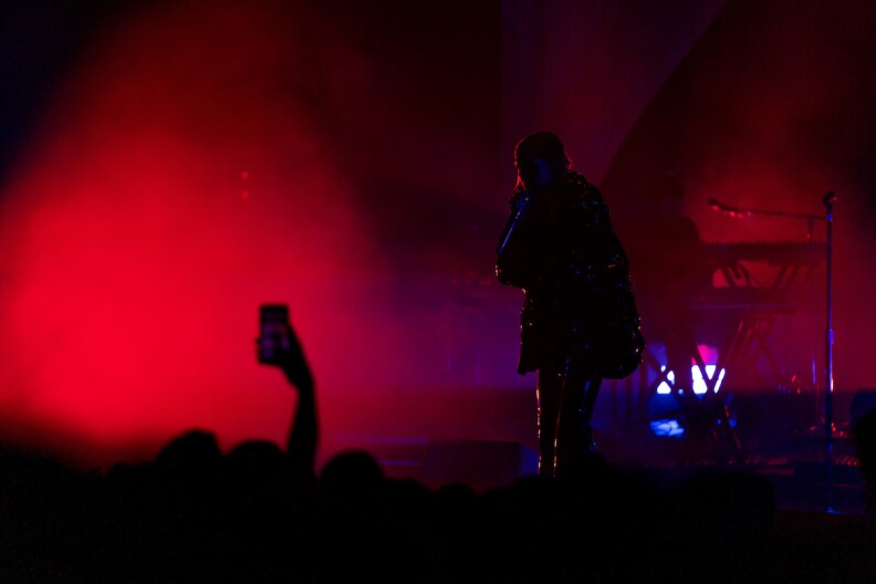 Lykke Li performs on stage in shadow in London