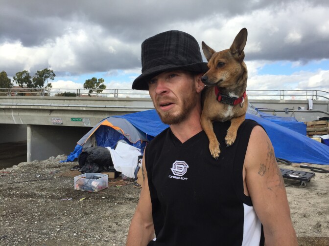 Jon Chandler, 33, rode out this week's El Nino storms inside his tent pitched on higher ground along the Santa Ana River Trail in Orange. Flood waters released from dam gates could force him to move to. January 7, 2015. 
