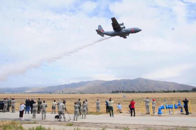 File: The California Air National Guard's C-130J drops water near onlookers during MAFFS annual certification and training at the 146th Airlift Wing in Port Hueneme, California on May 4, 2016.