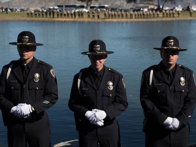 Riverside Police Officers attend Michael Crain's memorial at the Riverside National Cemetery.