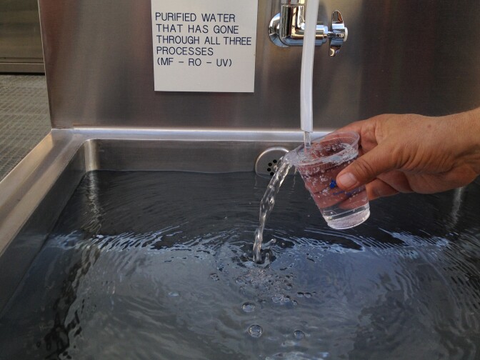 Samples of purified water flow from a tap at the Orange County Water District Groundwater Replenishment System plant in Fountain Valley, Calif. The plant takes treated sewage water and turns it into 70 million gallons of drinking water.