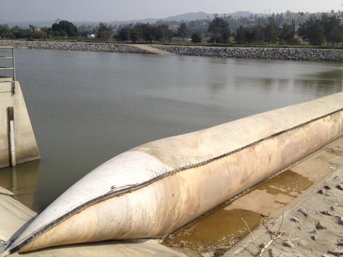 The Orange County Water District uses an inflatable rubber dam across the Santa Ana River in Anaheim to divert river water that would otherwise flow to the ocean. The water flows into one of the district's recharge basins, where it eventually percolates into an underground aquifer that supplies water to 2.4 million Orange County residents. 