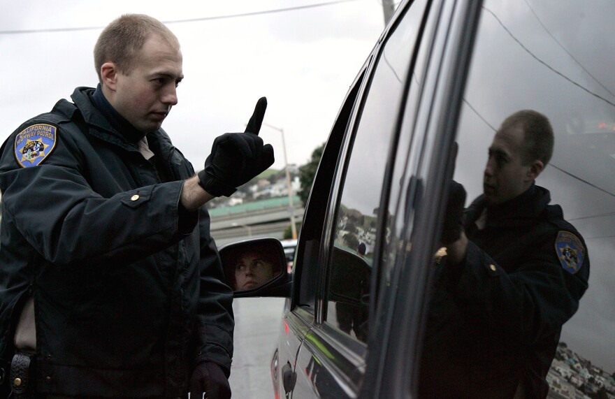 California Highway Patrol officer Mike Robinson gives a sobriety test to a man in car at a sobriety checkpoint December 26, 2004 in San Francisco, California. 