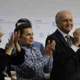 (L-R) French Ambassador for the international Climate Negotiations Responsible for COP21 Laurence Tubiana, Executive Secretary of the United Nations Framework Convention on Climate Change (UNFCCC) Christiana Figueres and Foreign Affairs Minister and President-designate of COP21 Laurent Fabius clap after adoption of a historic global warming pact at the COP21 Climate Conference in Le Bourget, north of Paris, on December 12, 2015. Envoys from 195 nations on December 12 adopted to cheers and tears a historic accord to stop global warming, which threatens humanity with rising seas and worsening droughts, floods and storms. AFP PHOTO / FRANCOIS GUILLOT / AFP / FRANCOIS GUILLOT        (Photo credit should read FRANCOIS GUILLOT/AFP/Getty Images)