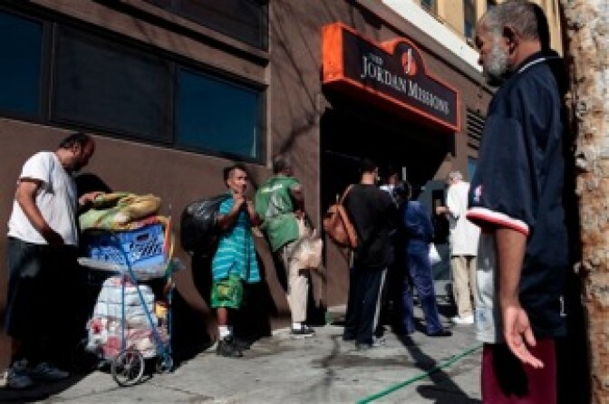 A group of homeless people wait in line outside a mission for food in Los Angeles, Thursday, Jan. 27, 2011. More than 5,000 volunteers, equipped with maps, clipboards and flashlights, scoured 4,000 square miles of Los Angeles County this week to count the homeless population. They peered down back alleys, scanned junk-filled cars, and checked crevices around freeway underpasses in what officials say is the nation's largest homeless census.
