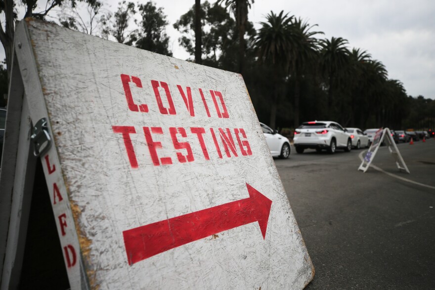 LOS ANGELES, CALIFORNIA - DECEMBER 07: Vehicles line up to enter a COVID-19 testing site at Dodger Stadium on the first day of new stay-at-home orders on December 7, 2020 in Los Angeles, California. Under state order, 33 million residents of California have entered into regional shutdowns in an attempt to contain the spread of the coronavirus as ICU capacity has dipped below 15 percent in most regions of the state. Barbershops, hair and nail salons, museums, zoos, movies theaters are closed while restaurants are open for takeout or delivery only. (Photo by Mario Tama/Getty Images)
