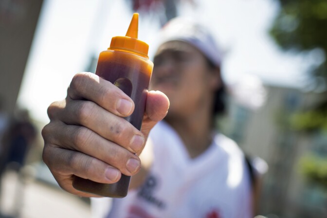 Competitor Kentaro Shimizu brings his own homemade ponzu sauce to the 2016 World Gyoza Eating Championship at the Japanese American Cultural and Community Center on Saturday, Aug. 20, 2016.
