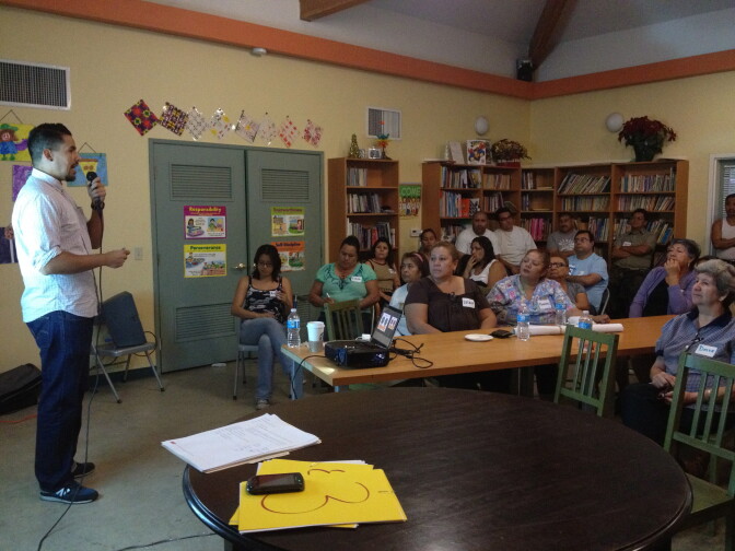An organizer from Boyle Heights' East LA Community Corporation speaks to immigrant street vendors about efforts to legalize their businesses. 