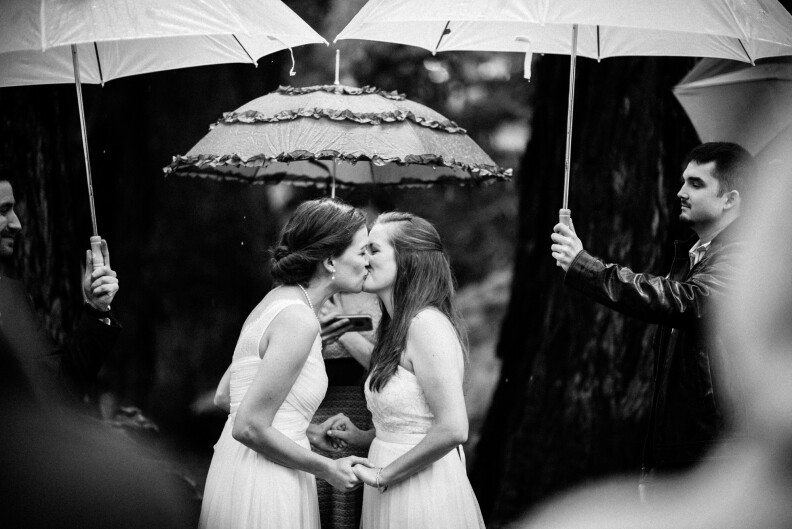 A couple kisses at the end of their vows