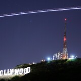 The Hollywood Sign is illuminated by the spotlight of a helicopter streaking past the sign at night on November 16, 2005 in Los Angeles, California.