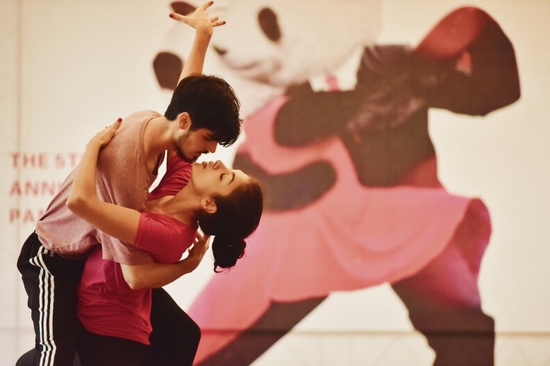 A man and woman dance closely.