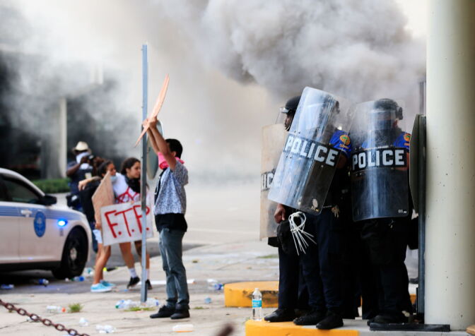 MIAMI, FLORIDA - MAY 30: Police in riot gear use tear gas and other means of crowd control as they blockade the station's parking garage as a rally in response to the police killing George Floyd on May 30, 2020 in Miami, Florida. Miami joins protest after the police killing of George Floyd. Four Minneapolis police officers have been fired after a video taken by a bystander was posted on social media showing Floyd's neck being pinned to the ground by an officer as he repeatedly said, "I can’t breathe". Floyd was later pronounced dead while in police custody after being transported to Hennepin County Medical Center. (Photo by Cliff Hawkins/Getty Images)