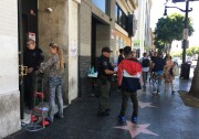 Former occupants of an illegally converted commercial building had to confer with security guards to retrieve their belongings after a police raid to vacate the building at 6362 Hollywood Blvd.