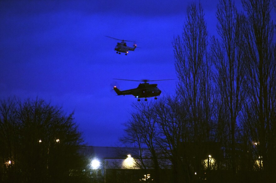 Helicopters fly over buildings in Dammartin-en-Goele, north-east of Paris, after two brothers suspected of slaughtering 12 people in an Islamist attack on French satirical newspaper Charlie Hebdo were shot dead by police, on Jan. 9, 2015.