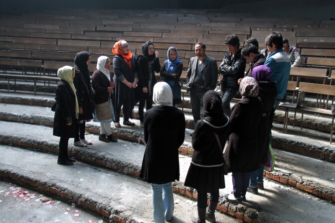 Royesh (center) holds an impromptu class in the auditorium of Marefat School in Kabul.