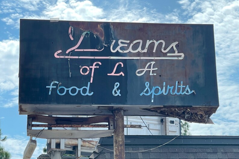 A rusted sign reads Dreams of L.A. Food & Spirits.