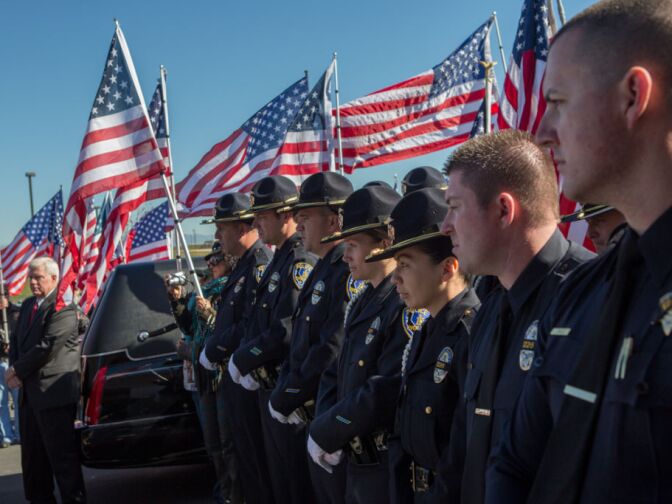 Riverside police line the walkway of the Grove Community Church for Michael Crain's funeral on February 13th, 2013 in Riverside, Calif. Crain was shot dead by Christopher Dorner on February 7th.