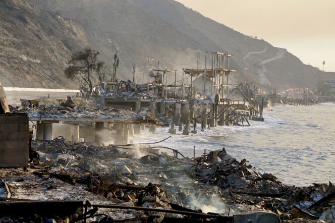 Smoldering ruins on pillars that are set into the ocean.