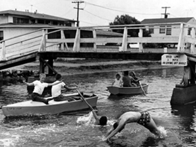 "Youngsters still go swimming and boating in Venice's Grand canal. Photo dated: July 29, 1962."