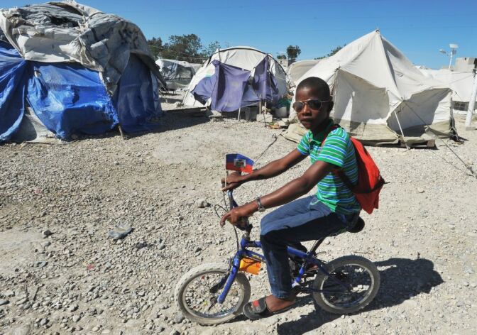 A view of a tent city is seen on January 8, 2013 in Marassa, a suburb of Port-au-Prince. Three years after the earthquake that devastated Haiti, 360,000 people are still living under tarps: among them, the inhabitants of the camps 'Marassa', located northeast of Port-au-Prince, who feel abandoned by everyone. About 750 families, or 5,000 people, coexist in these makeshift camps three 'Marassa' 9, 10 and 14, under the permanent threat of a large river that runs through the neighborhood. 