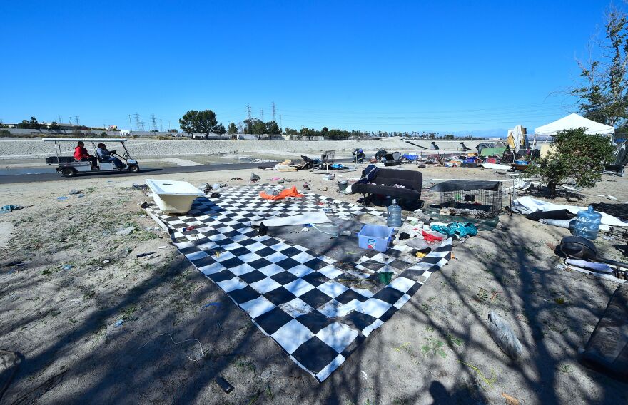 A homeless encampment on the side of the road.