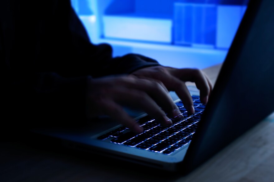 Fingers typing on a laptop keyboard