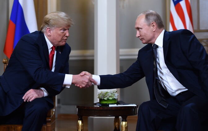 TOPSHOT - Russian President Vladimir Putin (R) and US President Donald Trump shake hands before a meeting in Helsinki, on July 16, 2018. (Photo by Brendan Smialowski / AFP)        (Photo credit should read BRENDAN SMIALOWSKI/AFP/Getty Images)