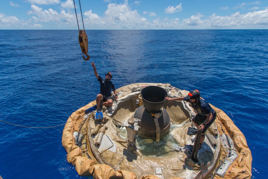 Divers retrieve the test vehicle for NASA's Low-Density Supersonic Decelerator off the coast of the U.S. Navy's Pacific Missile Range Facility in Kauai, Hawaii.
