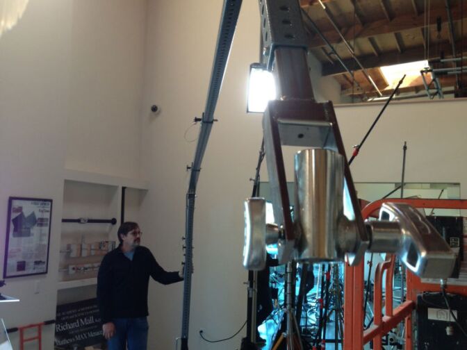 Richard Mall next to his invention, the Matthews Max Menace Arm.