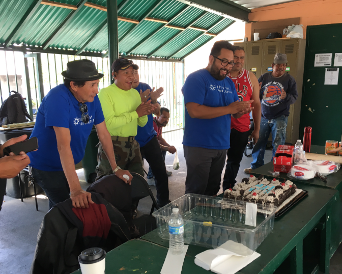 Day laborers including Rigoberto Torres, left, and staffers at the Central American Resource Center day labor center on Wilshire Boulevard near downtown L.A. celebrate "El Dia del Jornalero" on Friday, May 3, 2019. The L.A. City Council recently established the date as a day recognizing the city's day laborers, most of them immigrants, who do construction, landscaping and other jobs, often for little pay. 