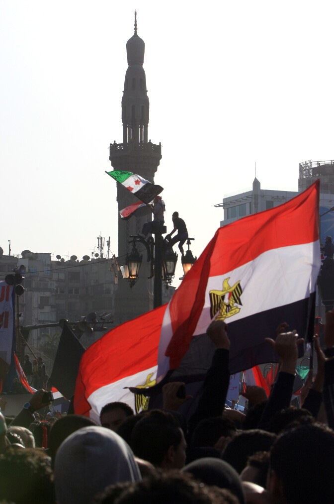 Egyptian wave their national flag as tens of thousands gather for a mass rally in Cairo's Tahrir Square on January 25, 2012, marking the first anniversary of the uprising that toppled president Hosni Mubarak as a debate raged over whether the rally was a celebration or a second push for change.        AFP PHOTO/MAHMUD HAMS (Photo credit should read MAHMUD HAMS/AFP/Getty Images)