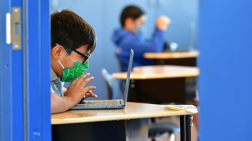 Students work on their laptop computers at St. Joseph Catholic School in La Puente, California on November 16, 2020, where pre-kindergarten to Second Grade students in need of special services returned to the classroom today for in-person instruction. - The campus is the second Catholic school in Los Angeles County to receive a waiver approval to reopen as the coronavirus pandemic rages on.  The US surpassed 11 million coronavirus cases Sunday, adding one million new cases in less than a week, according to a tally by Johns Hopkins University. (Photo by Frederic J. BROWN / AFP) (Photo by FREDERIC J. BROWN/AFP via Getty Images)