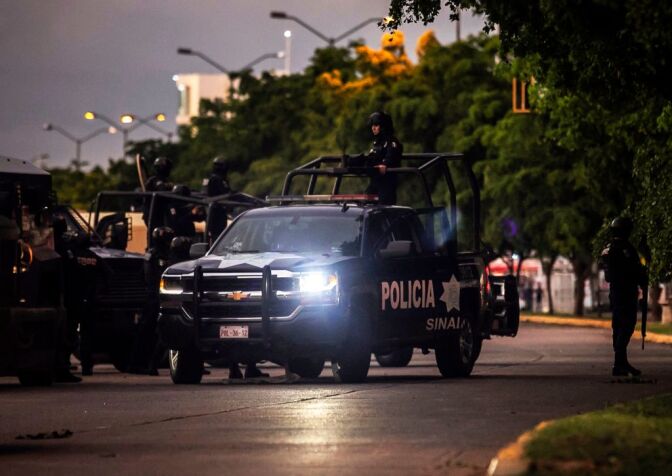 EDITORS NOTE: Graphic content / Mexican police patrol in a street of Culiacan, state of Sinaloa, Mexico, on October 17, 2019, after heavily armed gunmen in four-by-four trucks fought an intense battle with Mexican security forces. - Mexican security forces on Thursday arrested one son of jailed drug kingpin Joaquin "El Chapo" Guzman in an operation that triggered fighting in the western city of Culiacan, Security Minister Alfonso Durazo said. (Photo by RASHIDE FRIAS / AFP) (Photo by RASHIDE FRIAS/AFP via Getty Images)