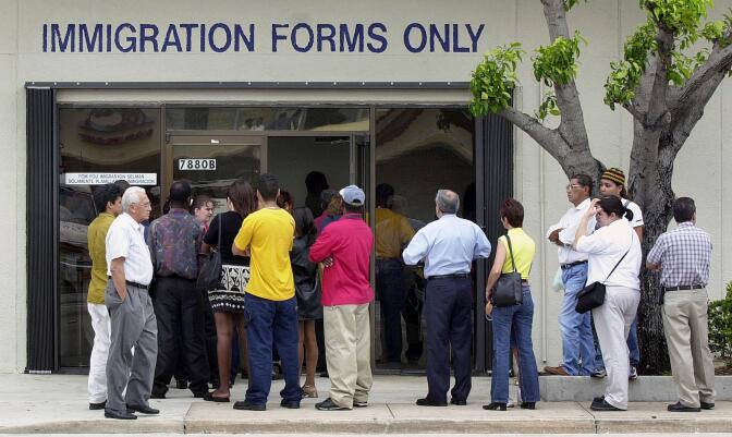 MIAMI, :  A line forms near the entrance of the Immigration and Naturalization Service office in Miami, 30 April 2001, as the midnight deadline approaches for illegal immigrants to apply for visas. The Legal Immigration and Family Equity Act allows illegal immigrants nationwide to apply for visas without having to return to their home countries and apply from there.     AFP PHOTO/RHONA WISE (Photo credit should read RHONA WISE/AFP/Getty Images)