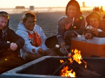 Jerry Wymore, Paige Brown, Sabrina Fuentes, and Nick Kern of Apple Valley roast marshmallows on Thursday evening, June 6, at a fire pit on Huntington Beach.