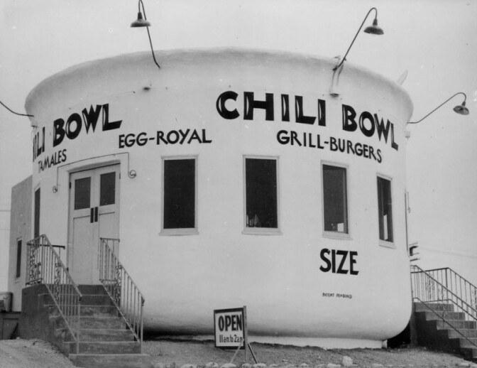 Launched in 1931 by former amateur boxer Art Whizin, the Chili Bowl chain had 22 outposts at its peak. Each building was round and shaped like a chili bowl with 26 stools around a circular counter where diners could get the signature dish: an open-faced burger blanketed with chili. This 1937 photo shows the original Chili Bowl, located at 3012 Crenshaw Boulevard.