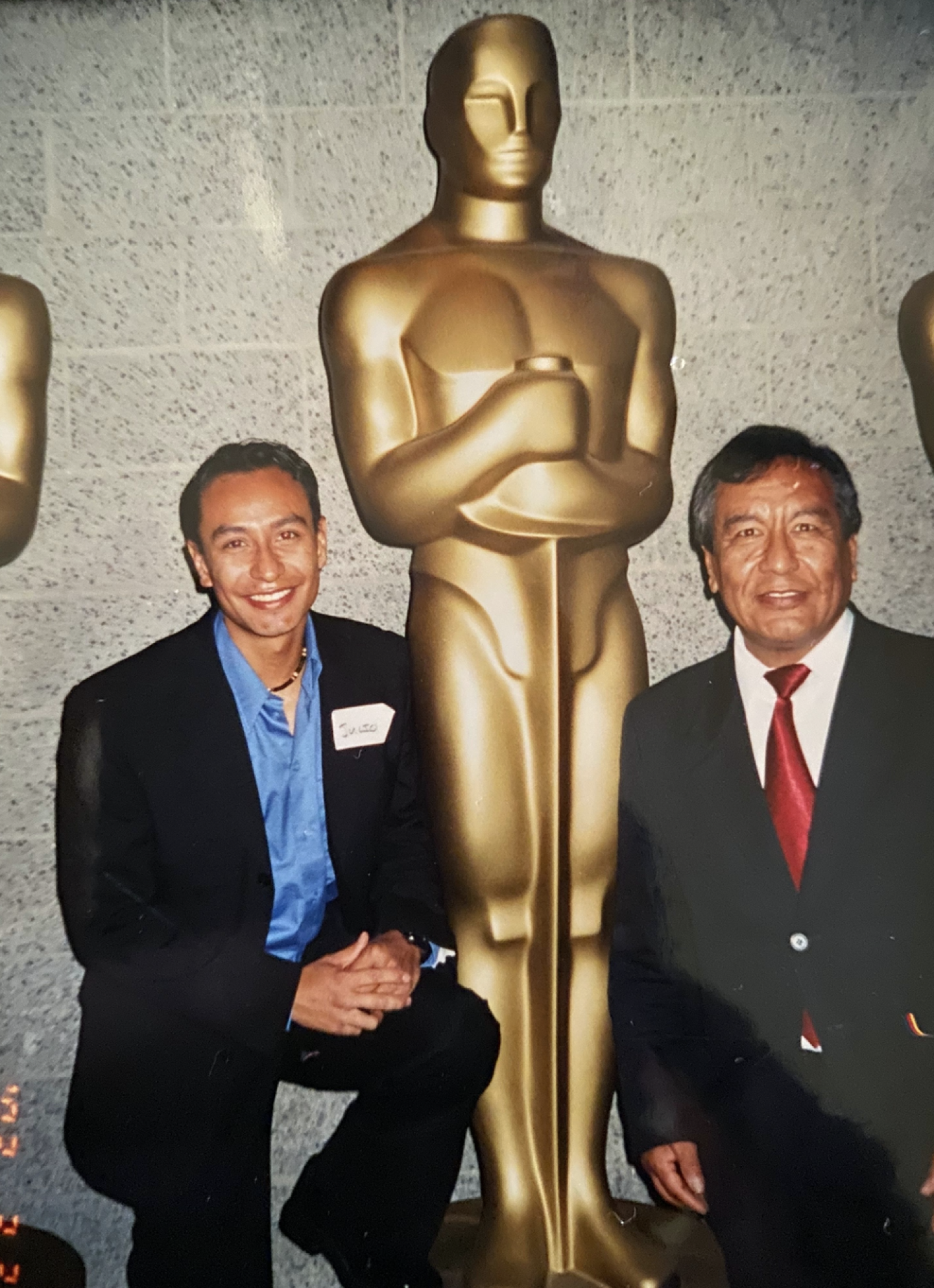 Julio, left, with his dad at the Academy Theater in 2002, not long after moving to the U.S.
