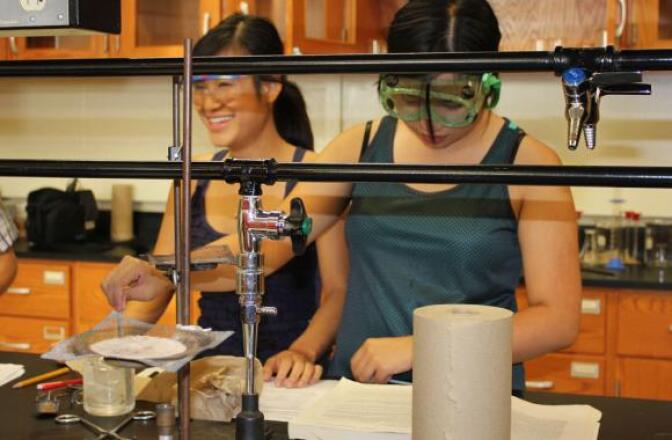 Binh Hua (left) and My Nguyen, both 18, work in the Garden City Community College chemistry lab. The two best friends graduated from high school in three years and after community college, plan to go on to universities. 