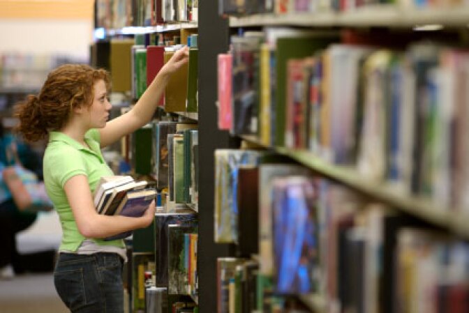 Female student selecting a library book
