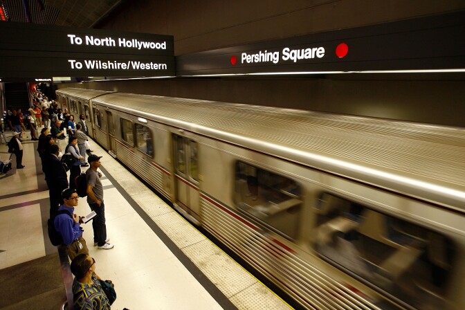 Passengers board a Metro Red Line train during rush hour. 